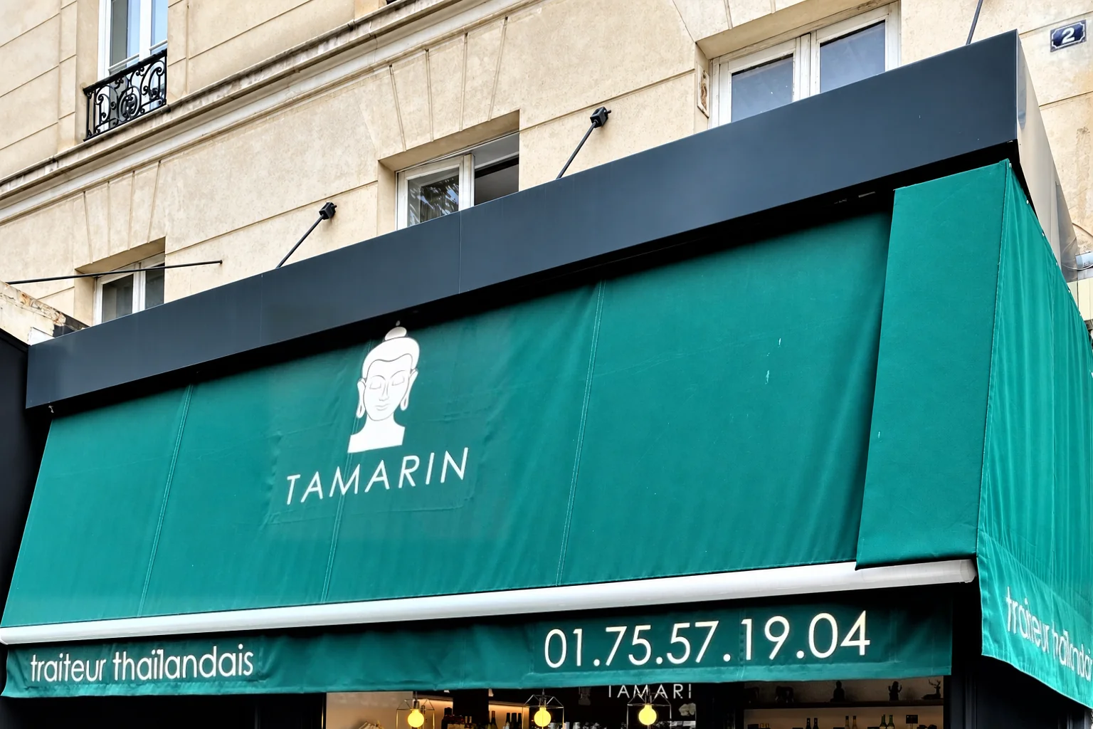 TAMARIN storefront with a green awning